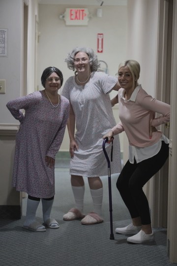 Three team members in grandma costumes for Halloween.