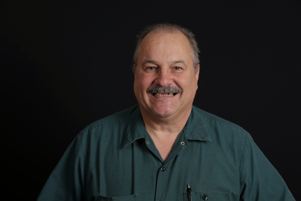 Before full implant treatment — discolored, worn teeth.